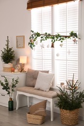 Photo of Beautiful room interior decorated for Christmas with potted firs