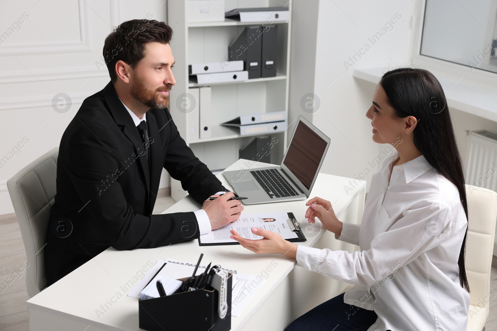 Photo of Human resources manager conducting job interview with applicant in office