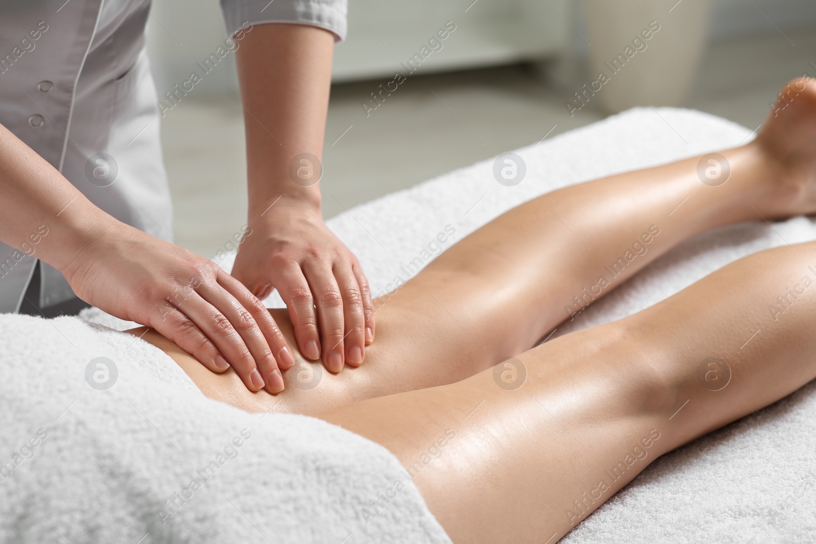 Photo of Woman receiving leg massage in spa salon, closeup