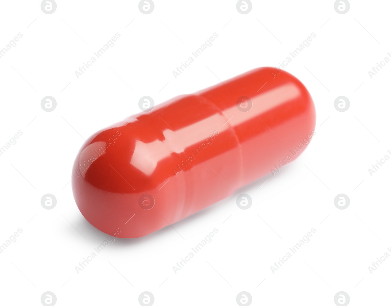 Photo of One red pill on white background. Medicinal treatment