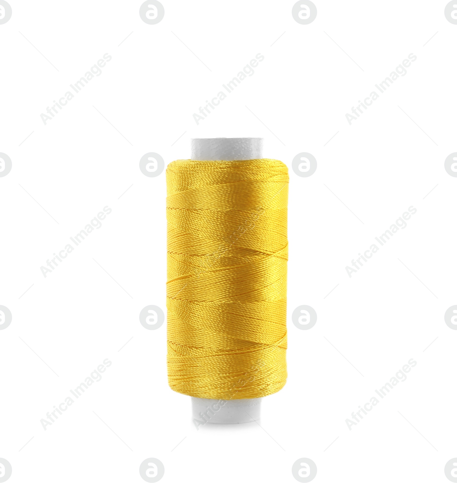 Photo of Spool of yellow sewing thread isolated on white