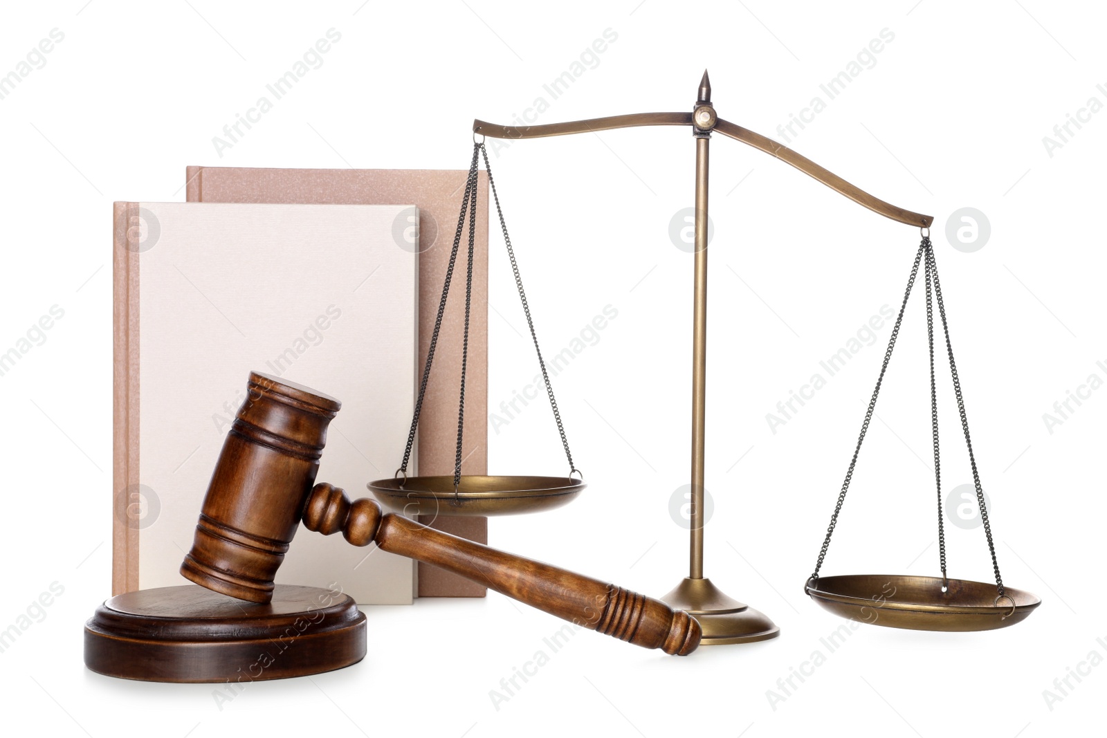 Photo of Wooden gavel, books and scales of justice on white background