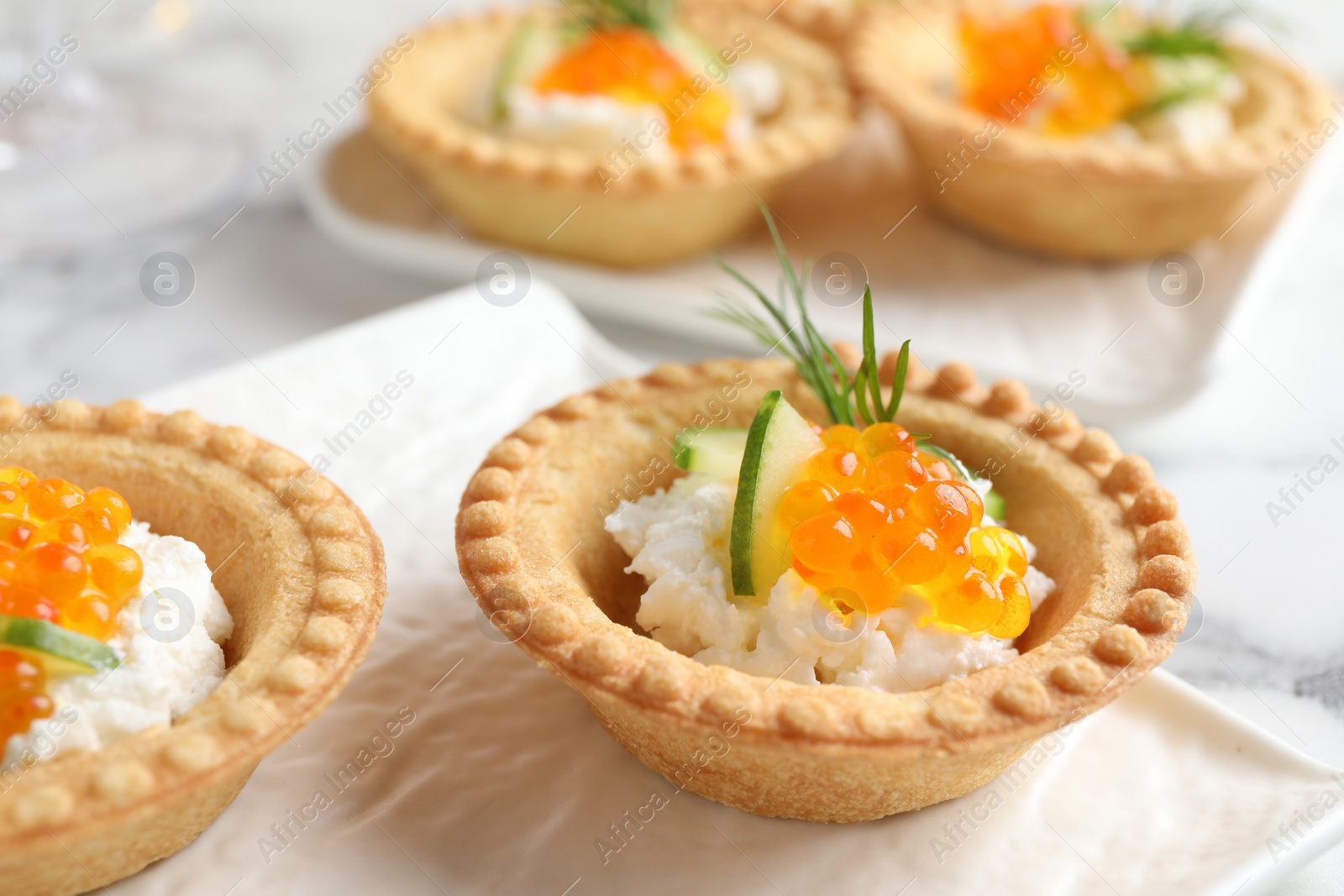 Photo of Delicious canapes with red caviar on table, closeup