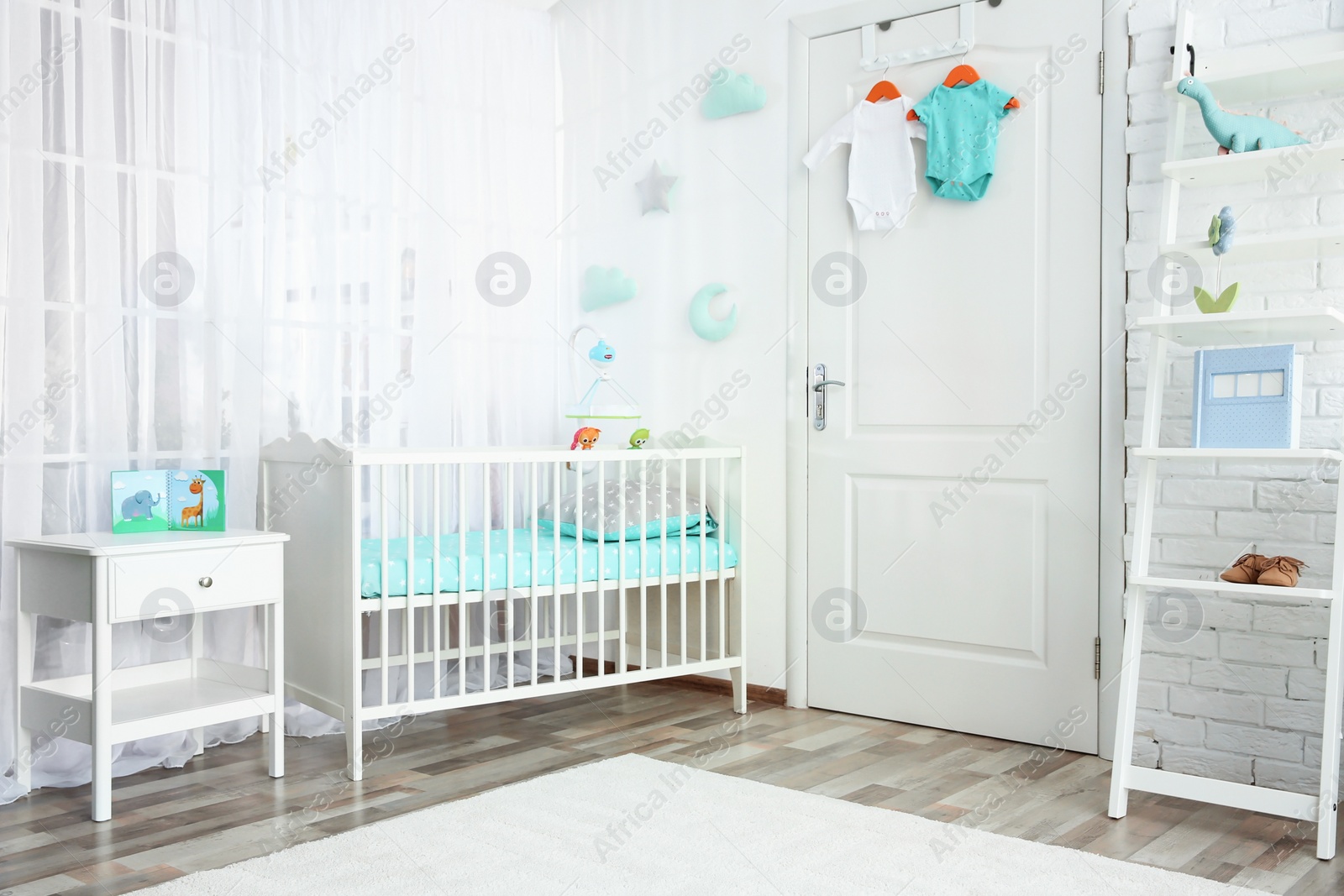 Photo of Modern interior of light cozy baby room with crib