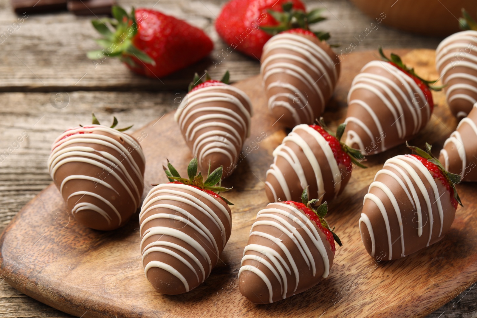 Photo of Delicious chocolate covered strawberries on wooden table, closeup