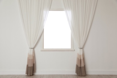 Photo of White wall with modern window and curtains indoors. Living room interior