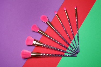 Set of makeup brushes on color background, flat lay