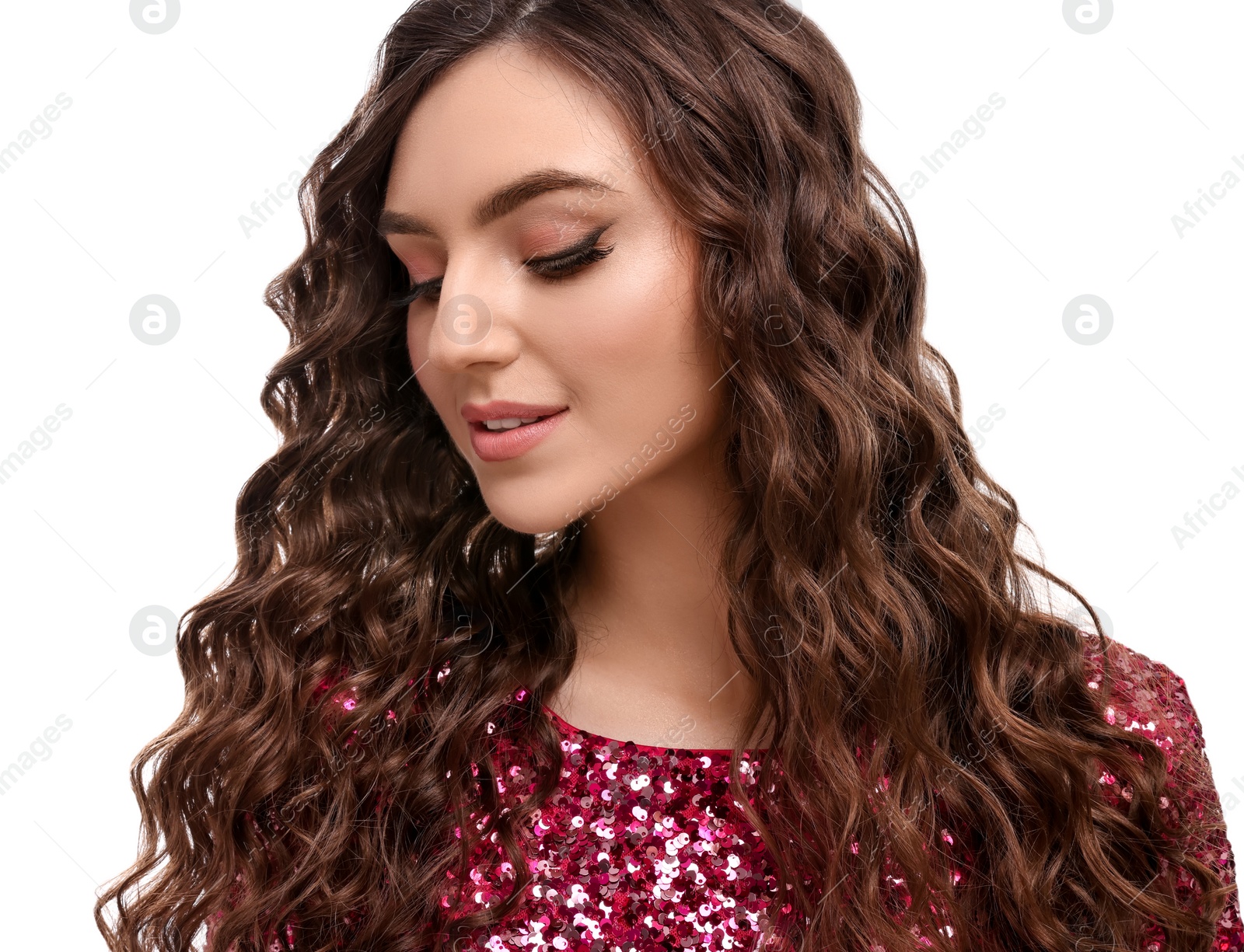 Photo of Beautiful young woman with long curly brown hair in pink sequin dress on white background