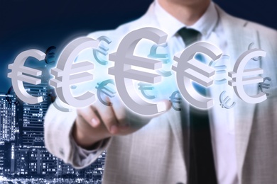 Money exchange concept. Businessman with euro currency symbols and city on background, closeup