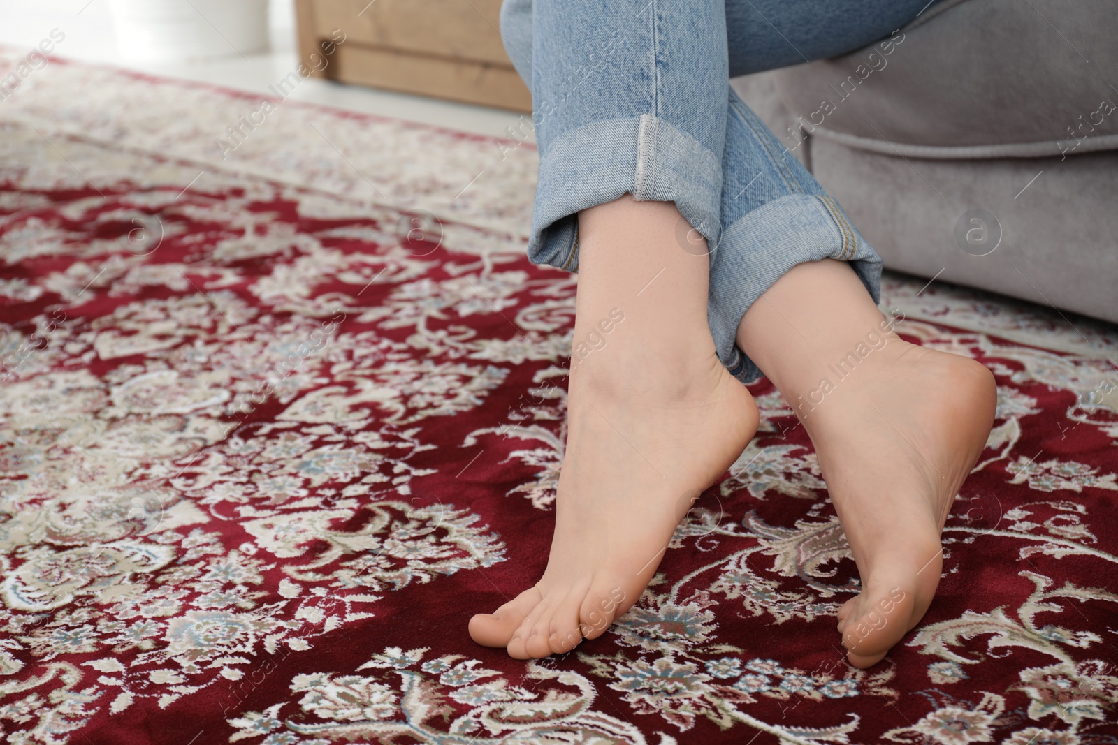 Photo of Woman sitting on sofa at home, closeup. Space for text