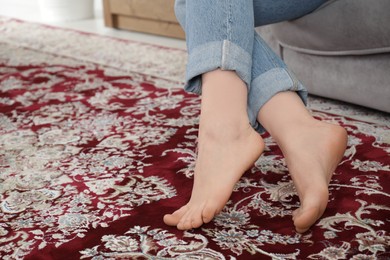 Photo of Woman sitting on sofa at home, closeup. Space for text