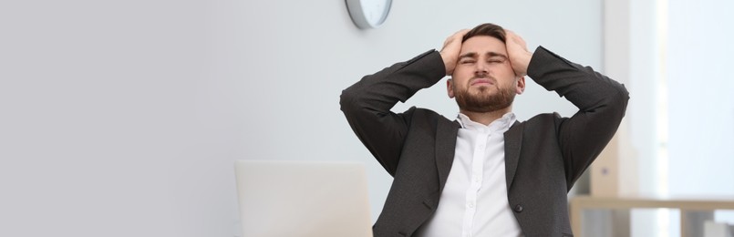 Image of Tired man at workplace in office, space for text. Banner design