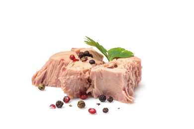 Pieces of canned tuna with parsley and pepper on white background