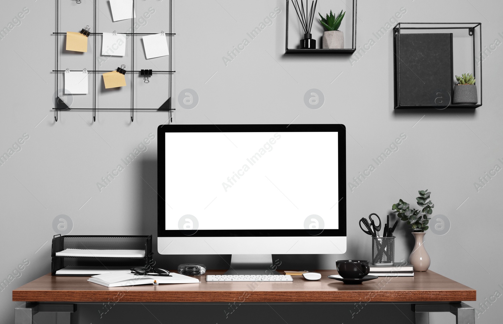 Photo of Cozy workspace with modern computer on wooden desk