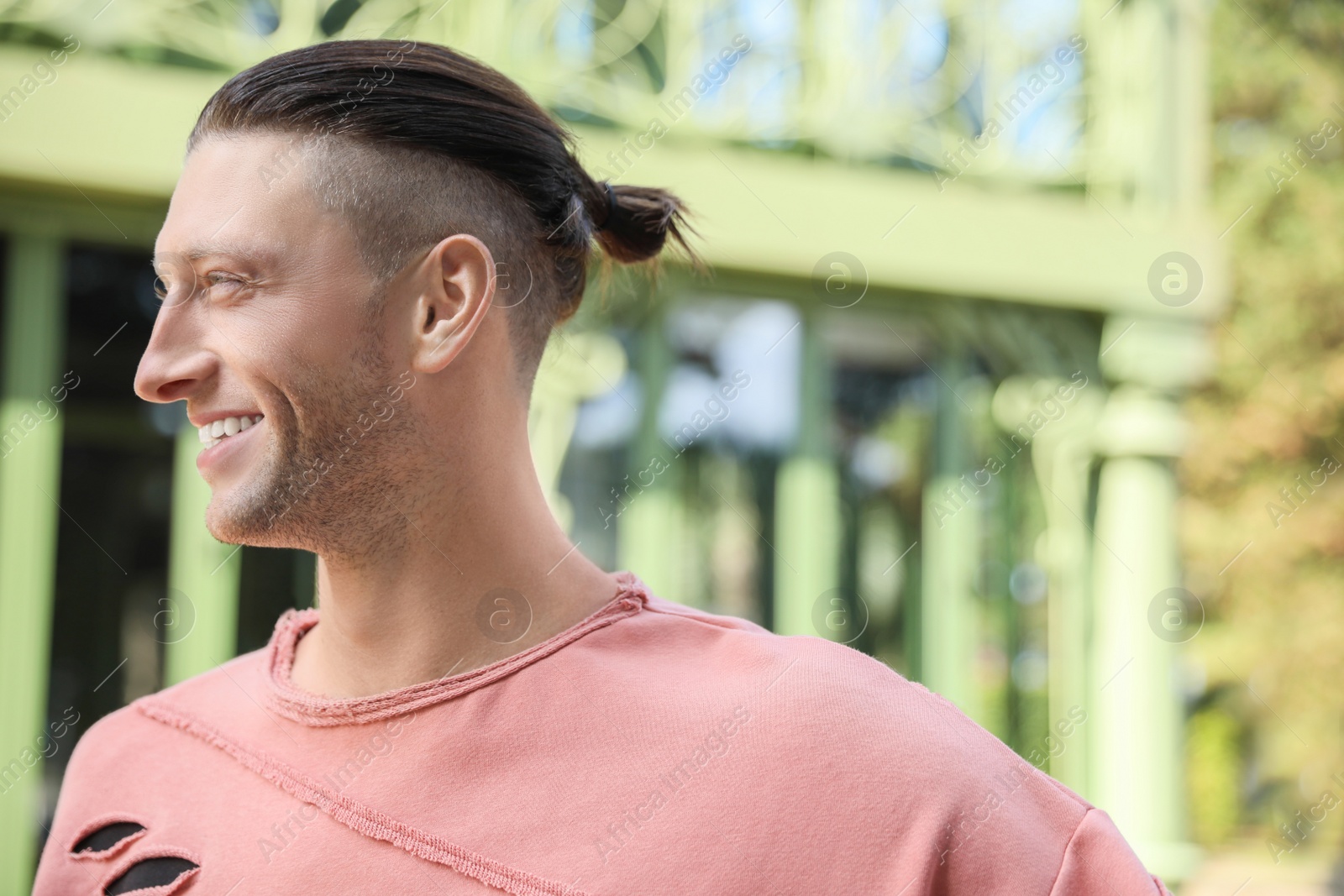 Photo of Portrait of handsome man outdoors, space for text