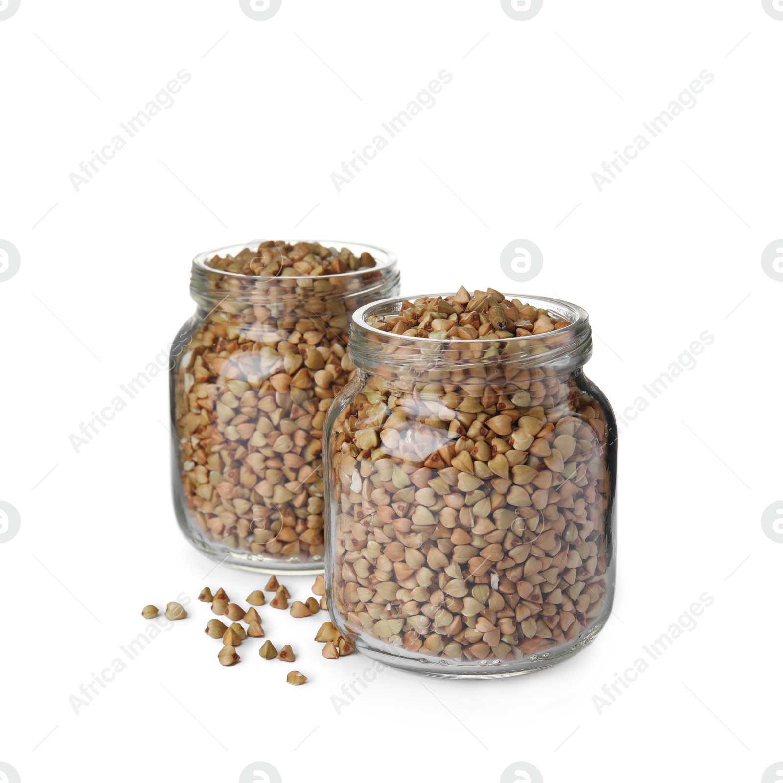 Photo of Organic green buckwheat in glass jars isolated on white