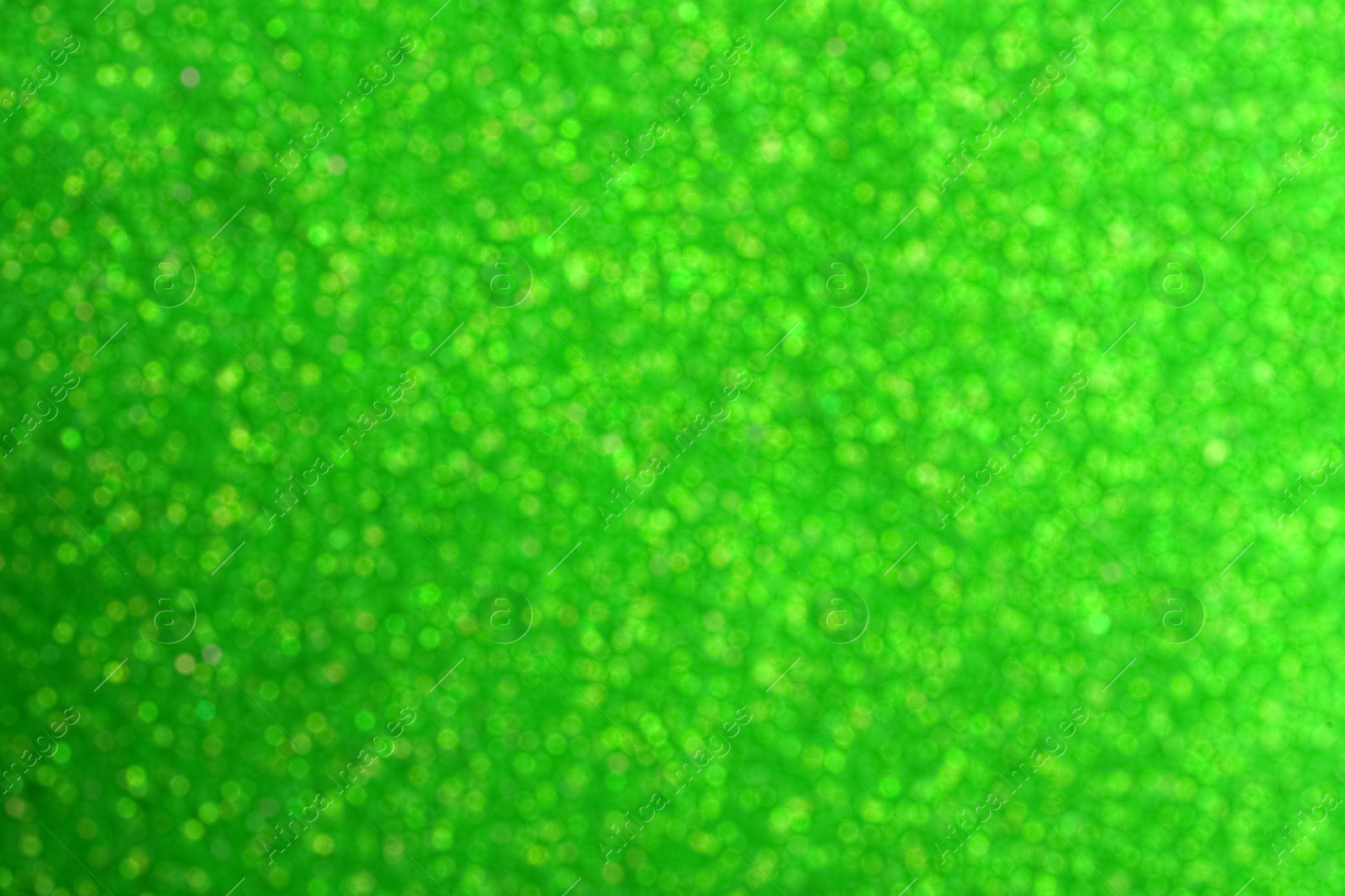 Image of St. Patrick day. Green glitter as background, blurred view. Bokeh effect