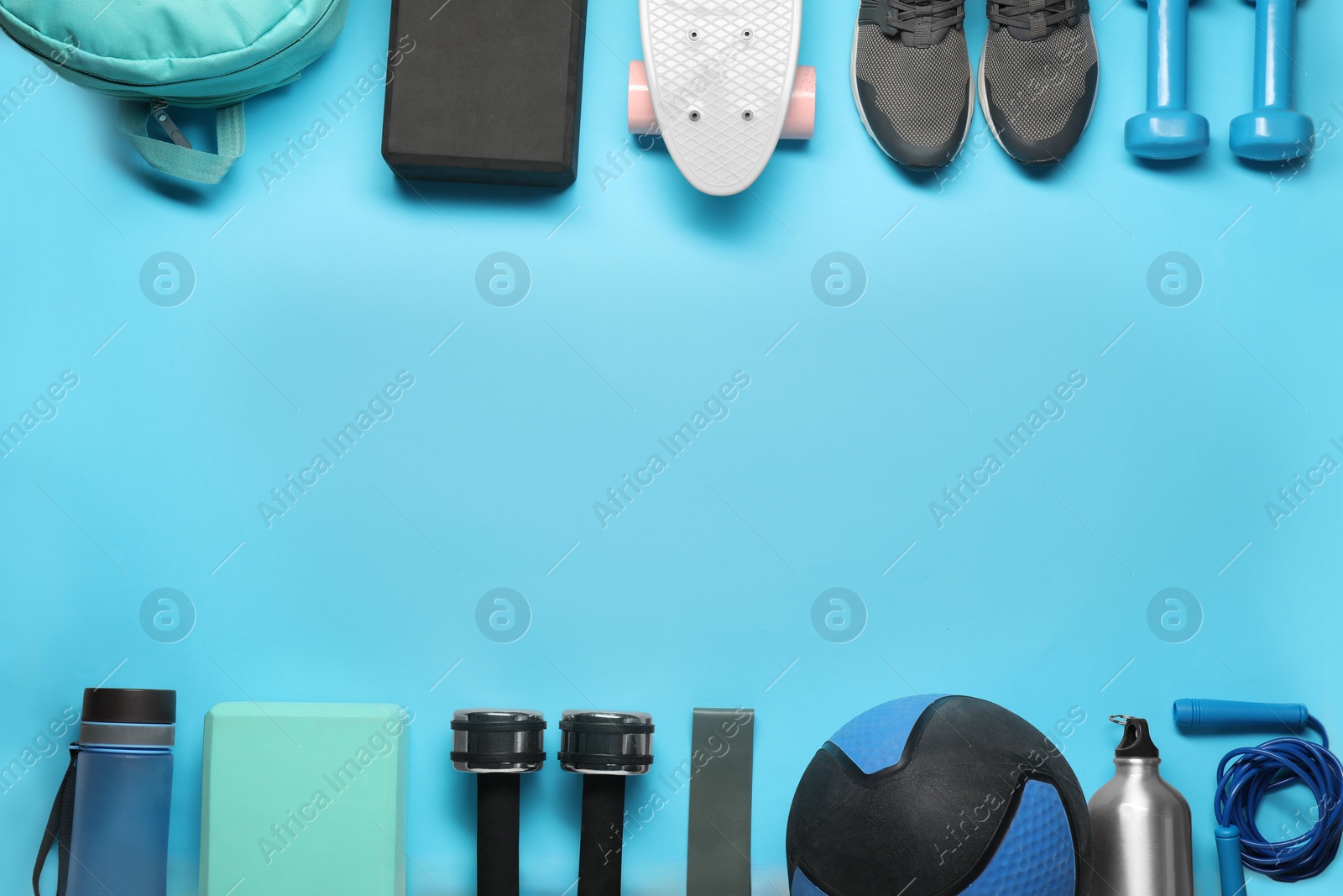 Photo of Frame made of different sports equipment on light blue background, flat lay. Space for text
