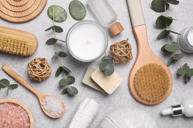 Photo of Flat lay composition with spa products and eucalyptus branches on light grey table