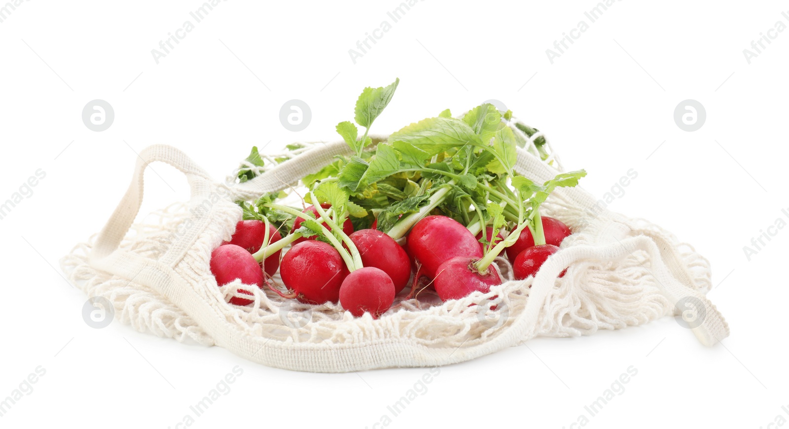 Photo of String bag with radishes isolated on white