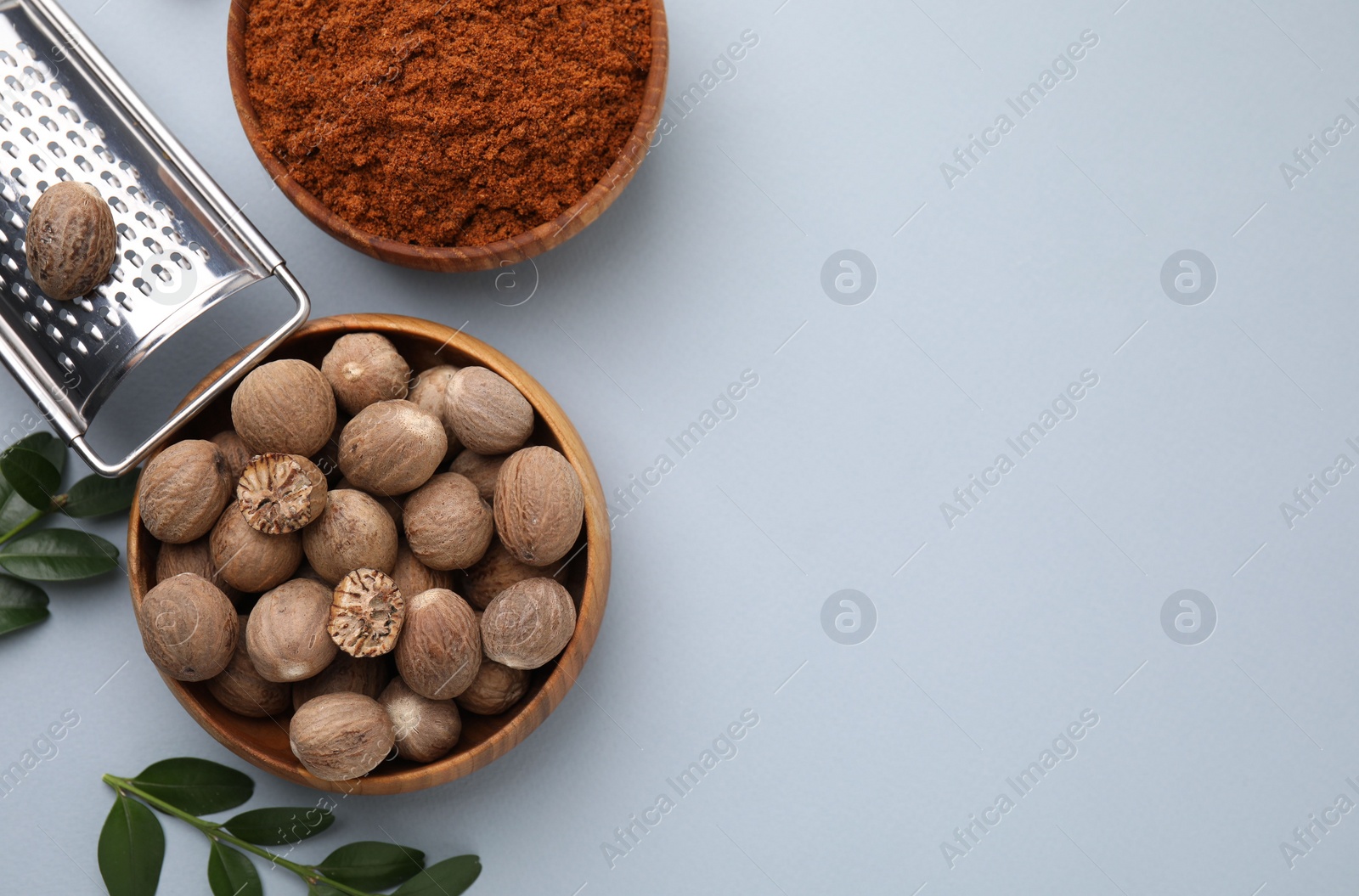 Photo of Flat lay composition with nutmegs on white background. Space for text