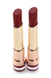 Two beautiful lipsticks on white background. Trendy makeup products