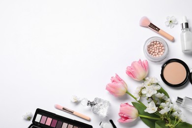 Photo of Flat lay composition with different makeup products and beautiful spring flowers on white background, space for text