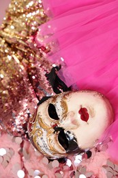 Photo of Carnival mask and beautiful pink costume with sequins, above view