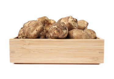 Photo of Wooden crate with fresh Jerusalem artichokes isolated on white