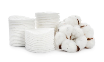 Photo of Composition with cotton pads and flowers on white background