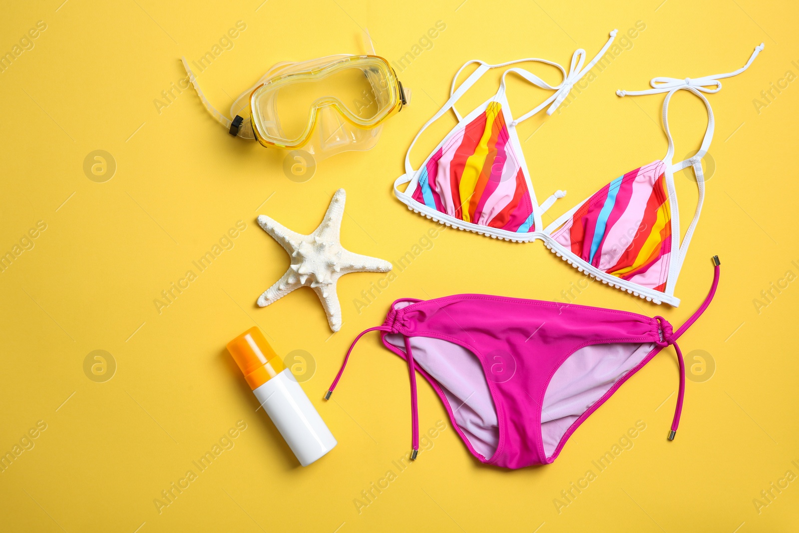 Photo of Flat lay composition with bikini and beach objects on color background