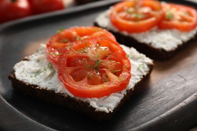 Photo of Delicious ricotta bruschettas with sliced tomatoes and dill on wooden table, closeup