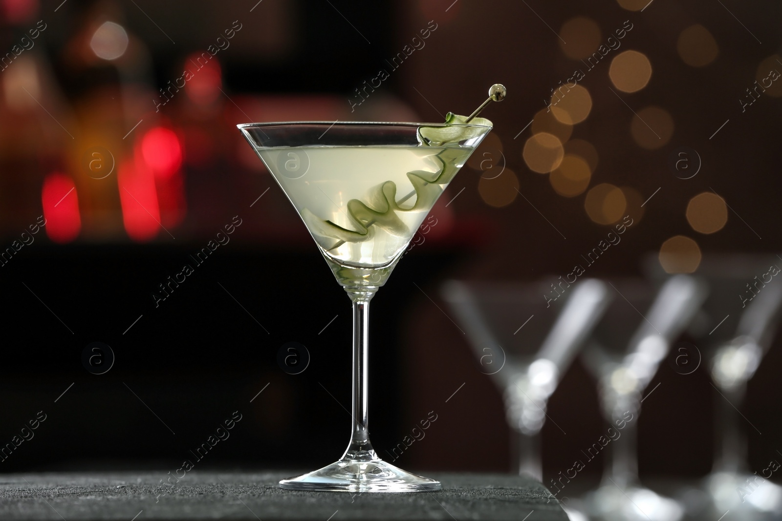 Photo of Glass of tasty cucumber martini on bar counter