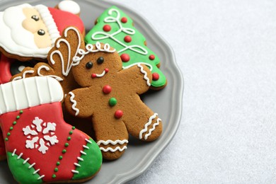 Photo of Tasty homemade Christmas cookies on light grey table, closeup. Space for text