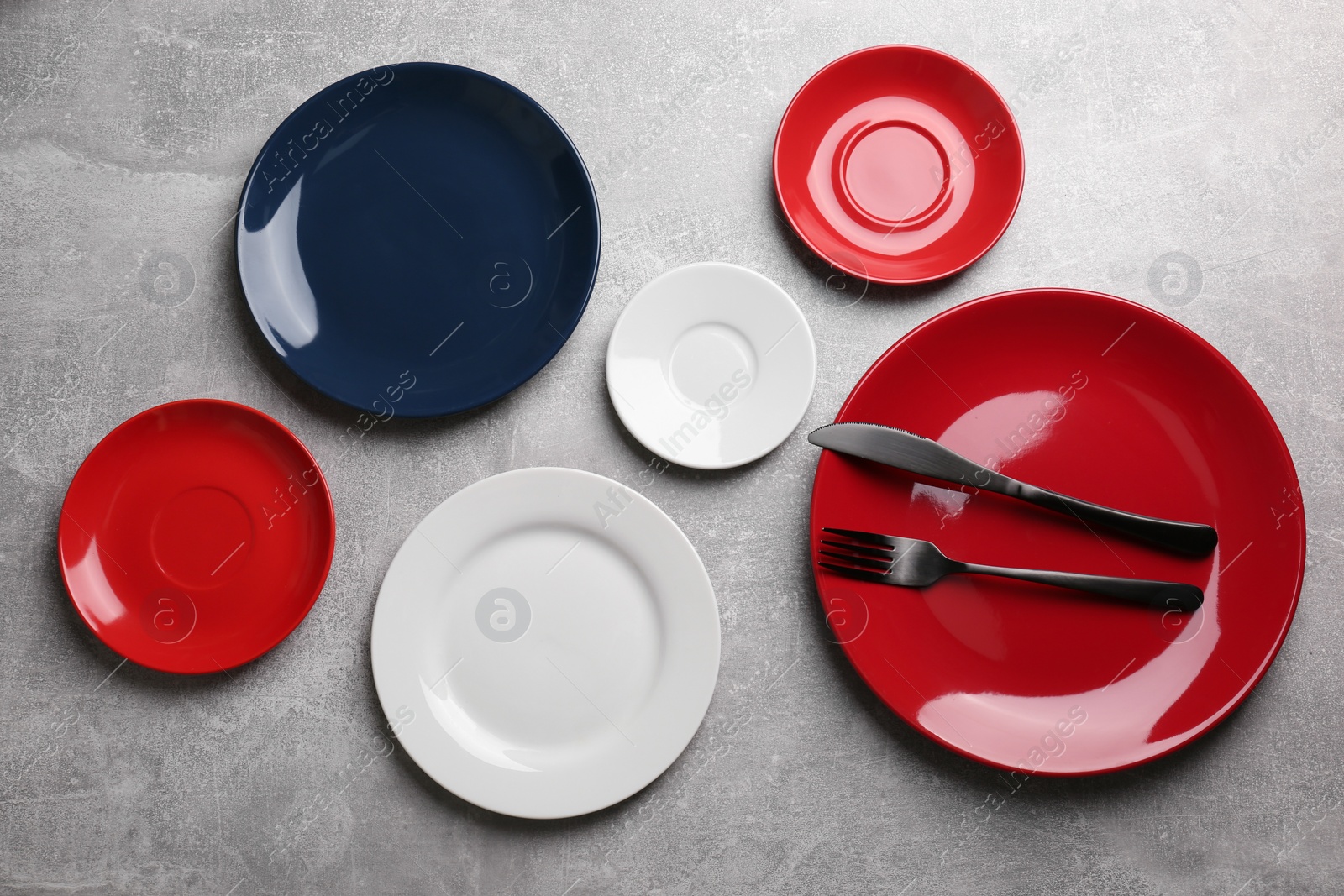 Photo of Flat lay composition with beautiful dishware on grey table