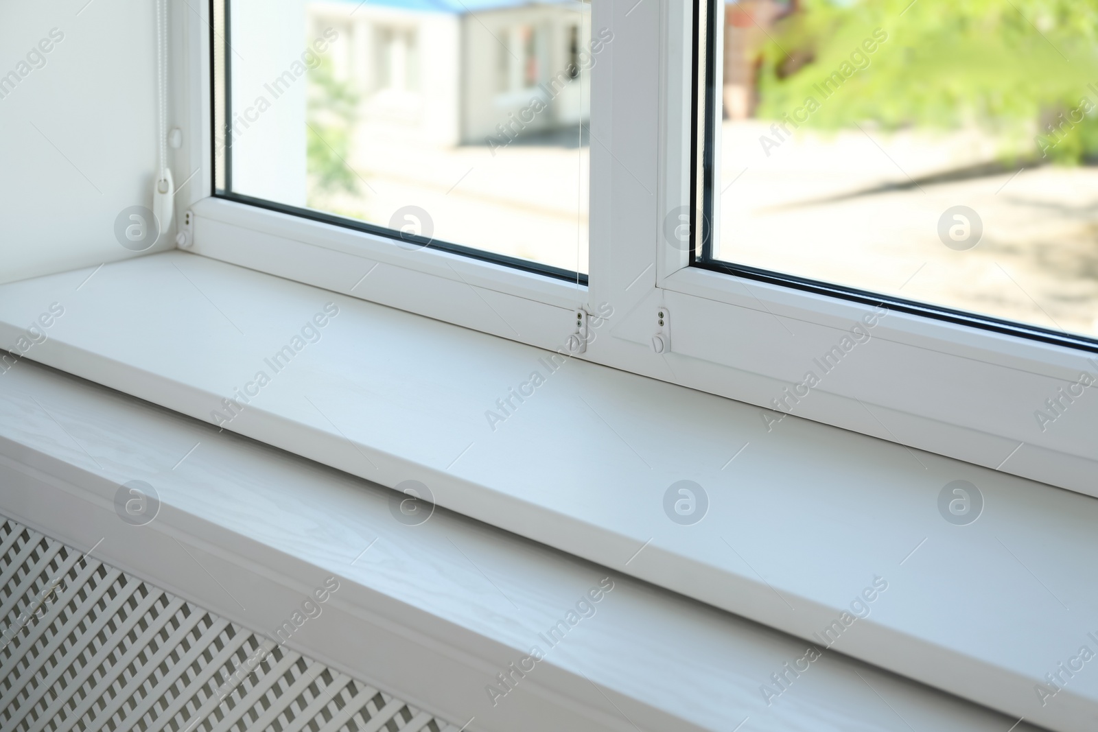 Photo of Closeup view of window with empty white sill