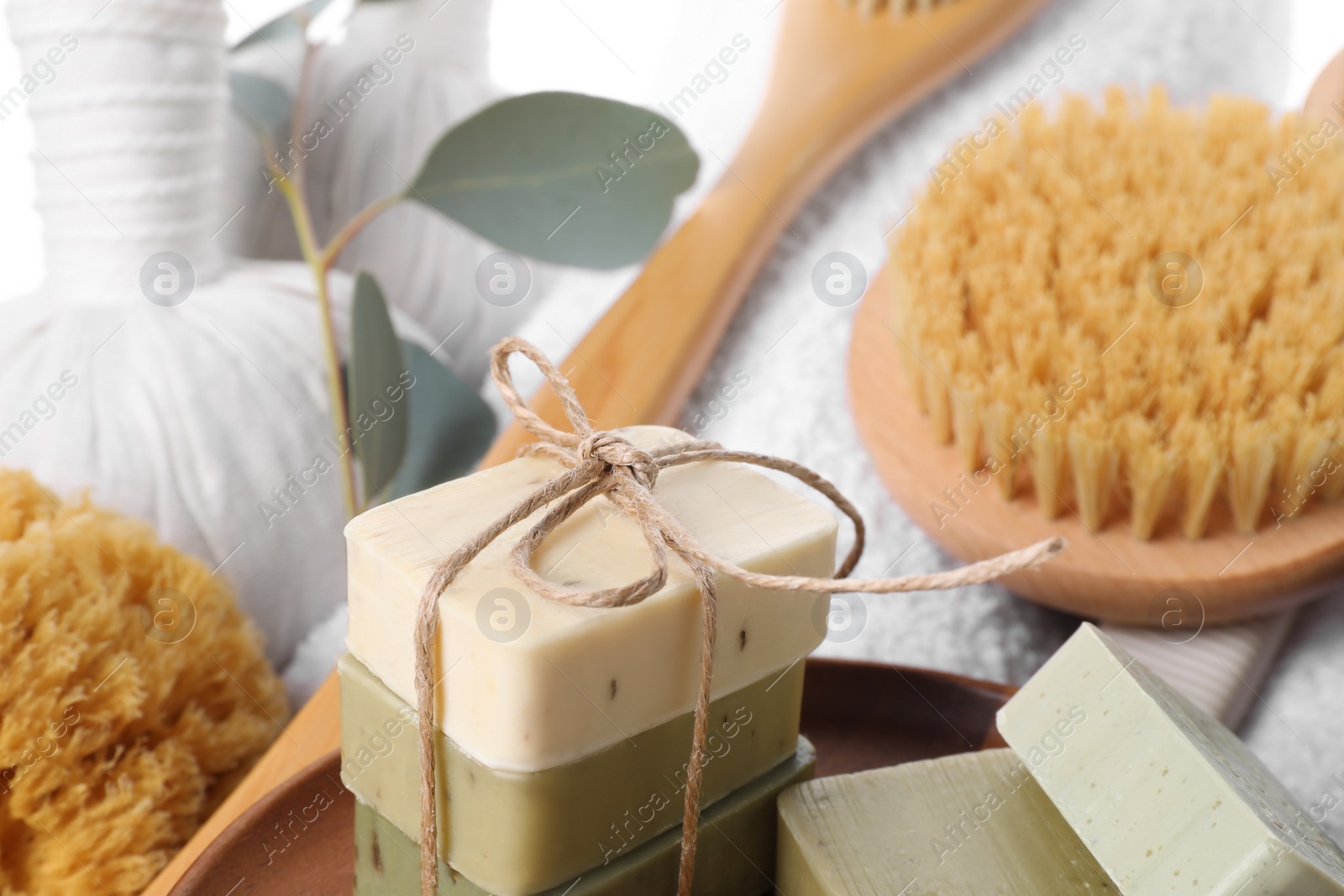 Photo of Spa composition with soap bars and brush, closeup