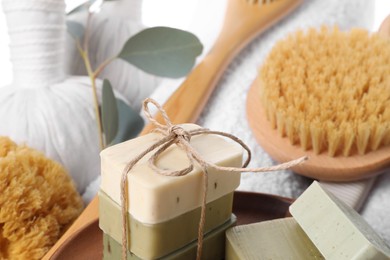 Photo of Spa composition with soap bars and brush, closeup