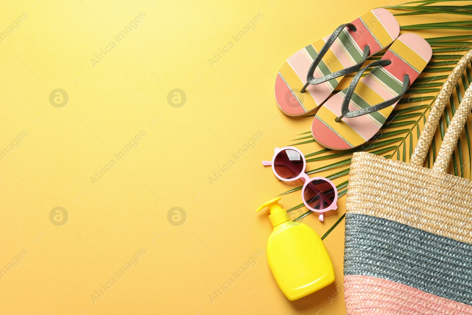 Photo of Flat lay composition with beach accessories on color background. Space for text