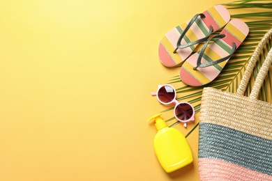 Flat lay composition with beach accessories on color background. Space for text