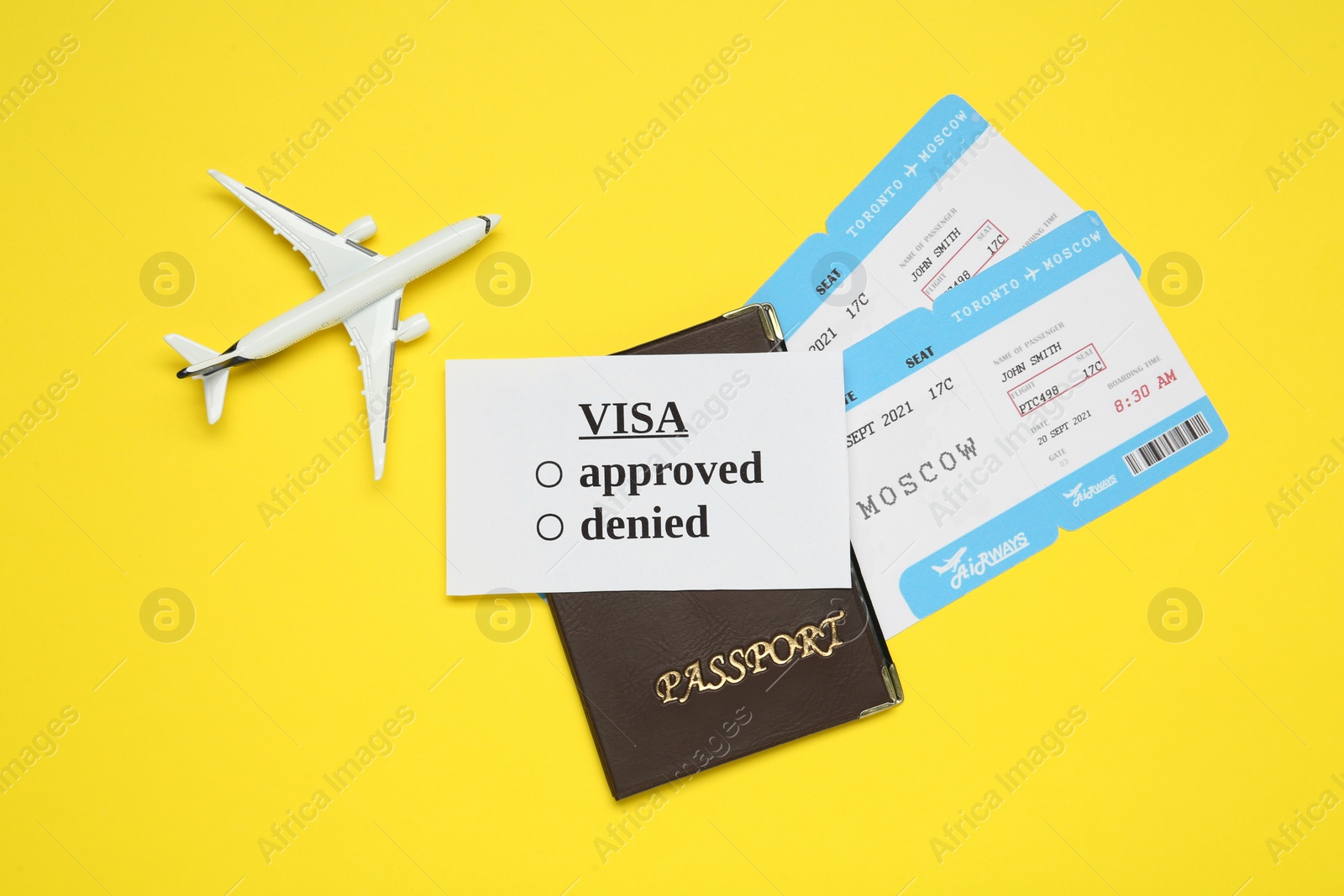 Photo of Flat lay composition with passport, toy plane and tickets on yellow background. Visa receiving