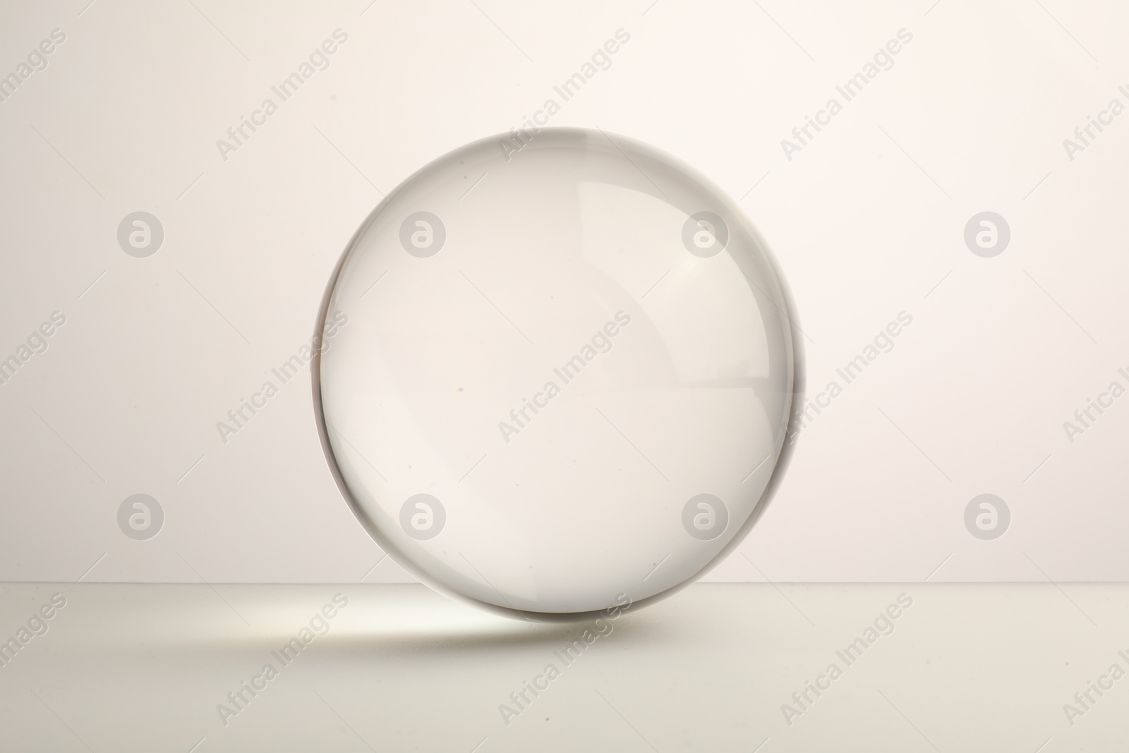 Photo of View of transparent glass ball on white background