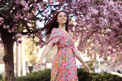 Photo of Beautiful woman near blossoming tree on spring day