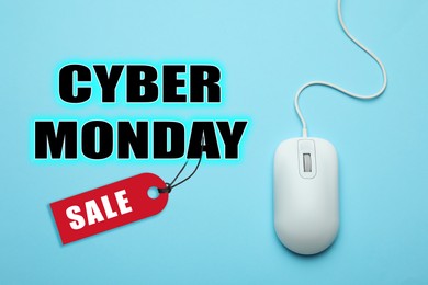 Image of Text Cyber Monday Sale and wired computer mouse on light blue background, top view