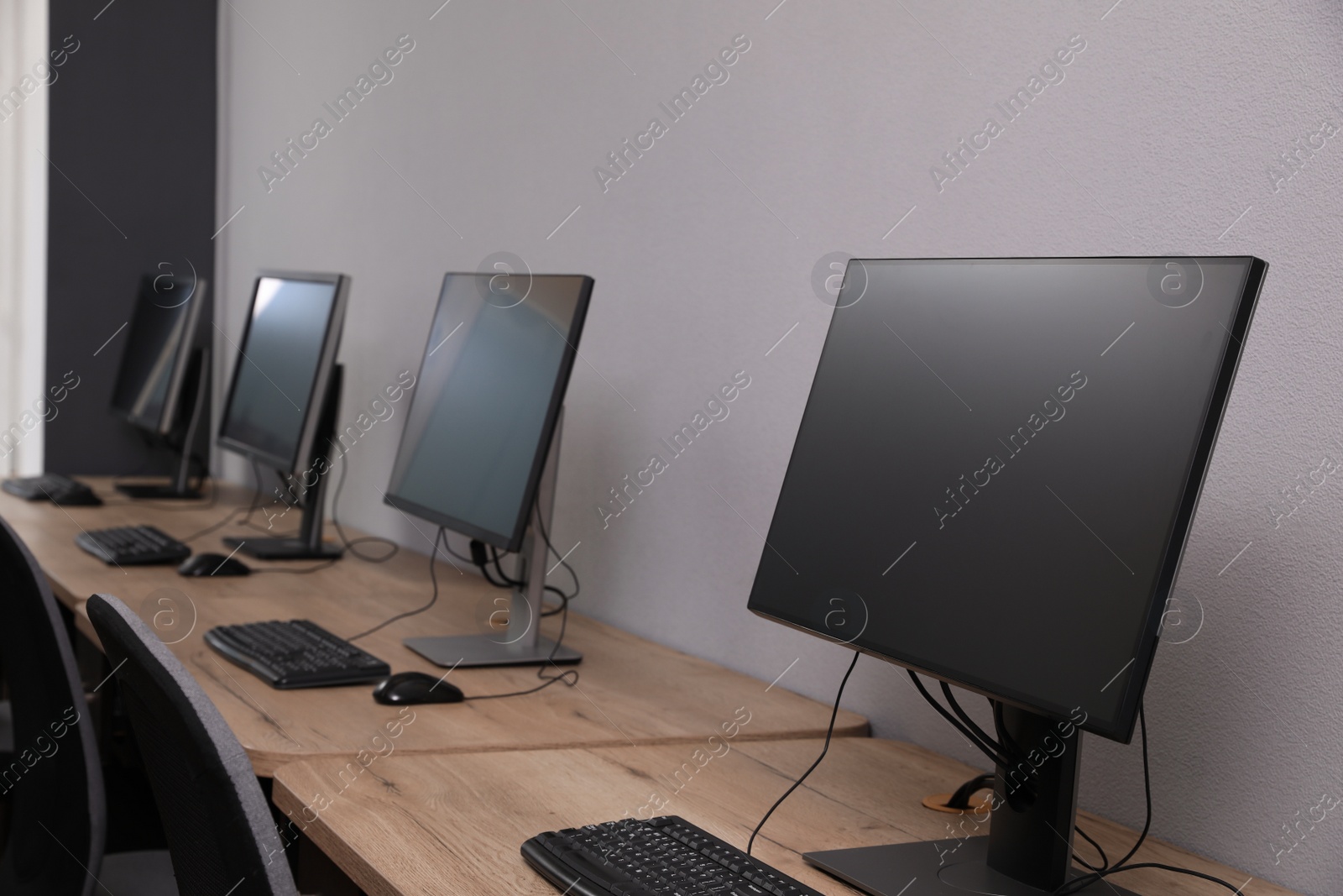 Photo of Many modern computers in open space office