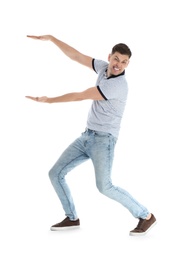 Emotional man in casual clothes holding something on white background