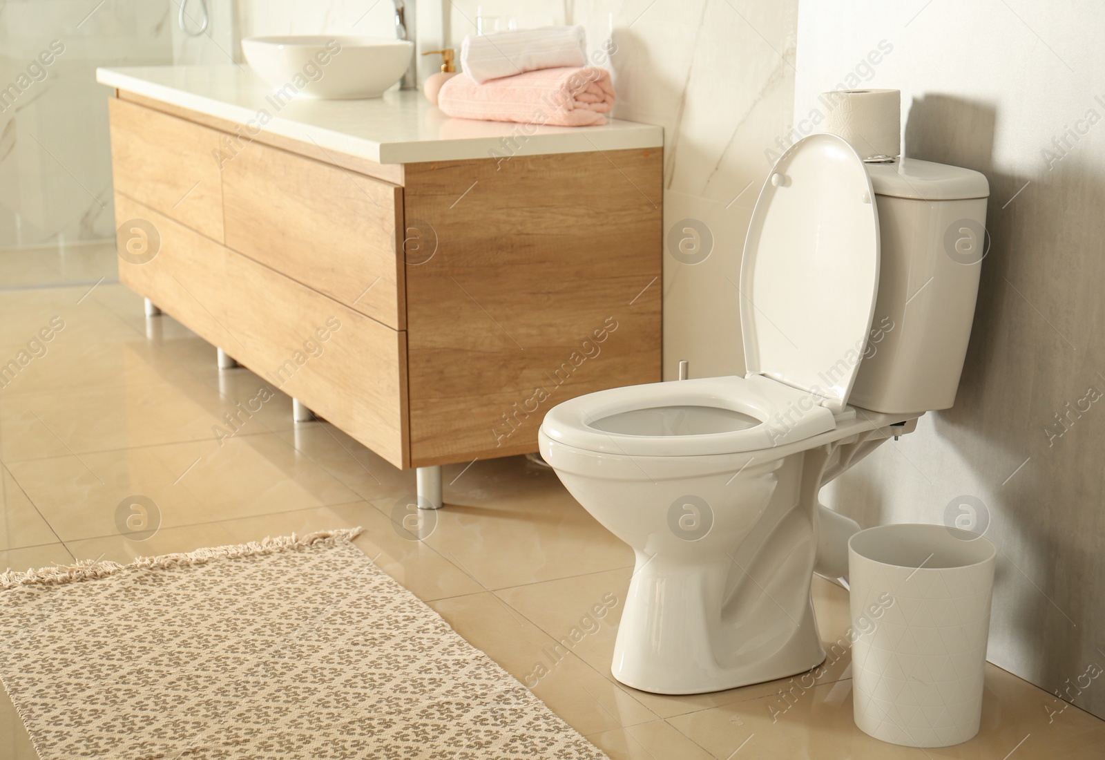 Photo of White toilet bowl in modern bathroom interior