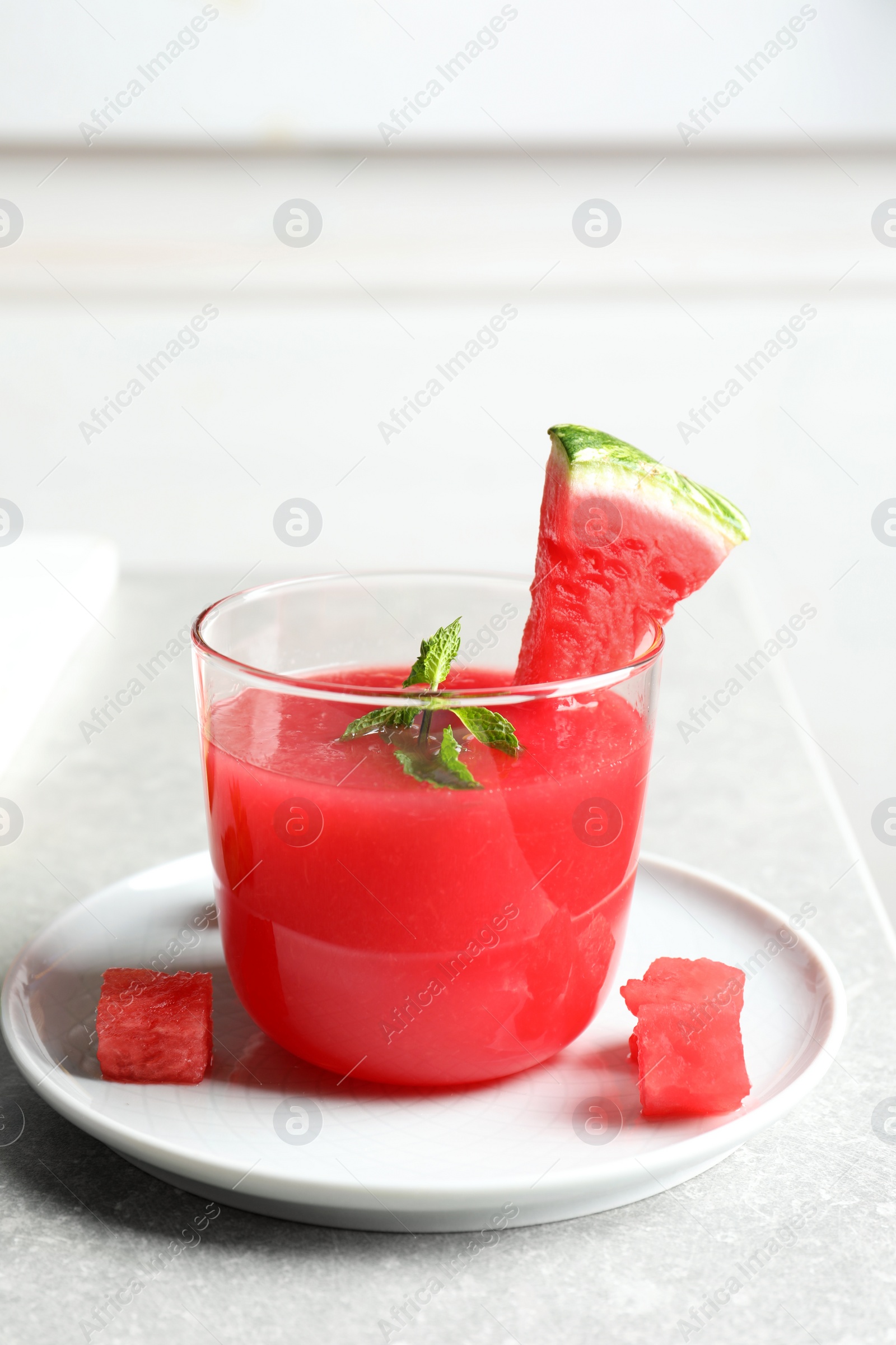 Photo of Summer watermelon drink with mint in glass served on table