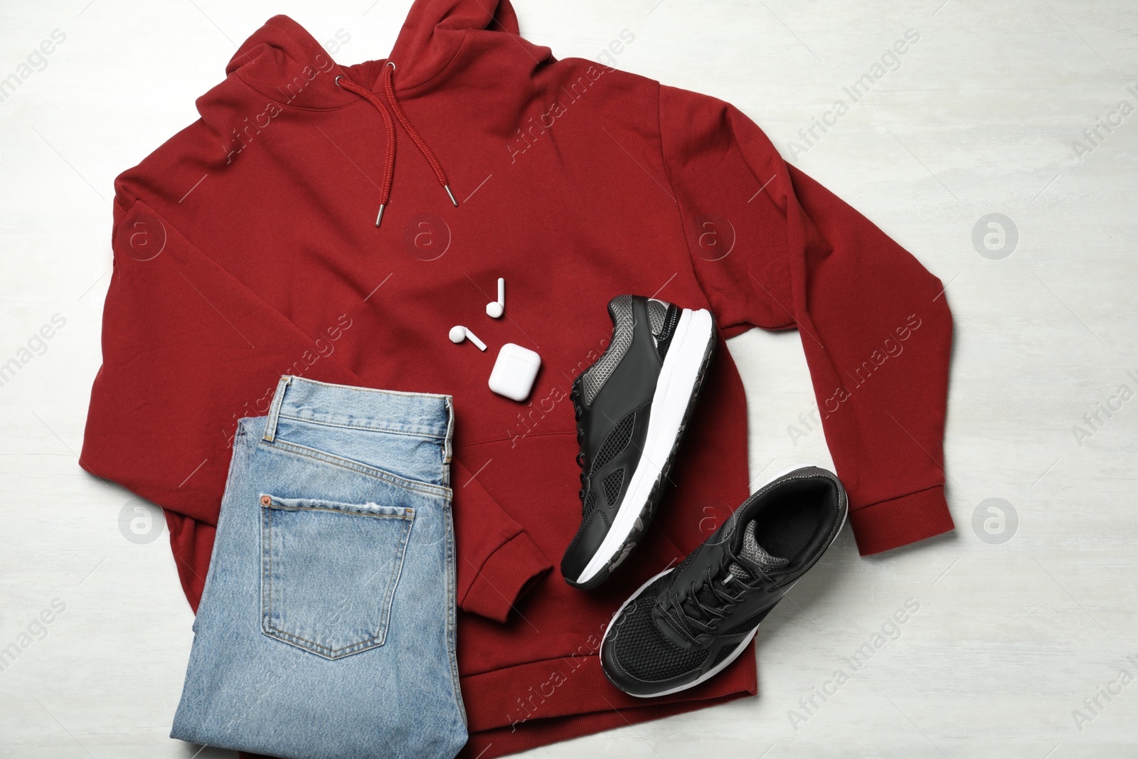 Photo of Flat lay composition with stylish sport shoes on light background