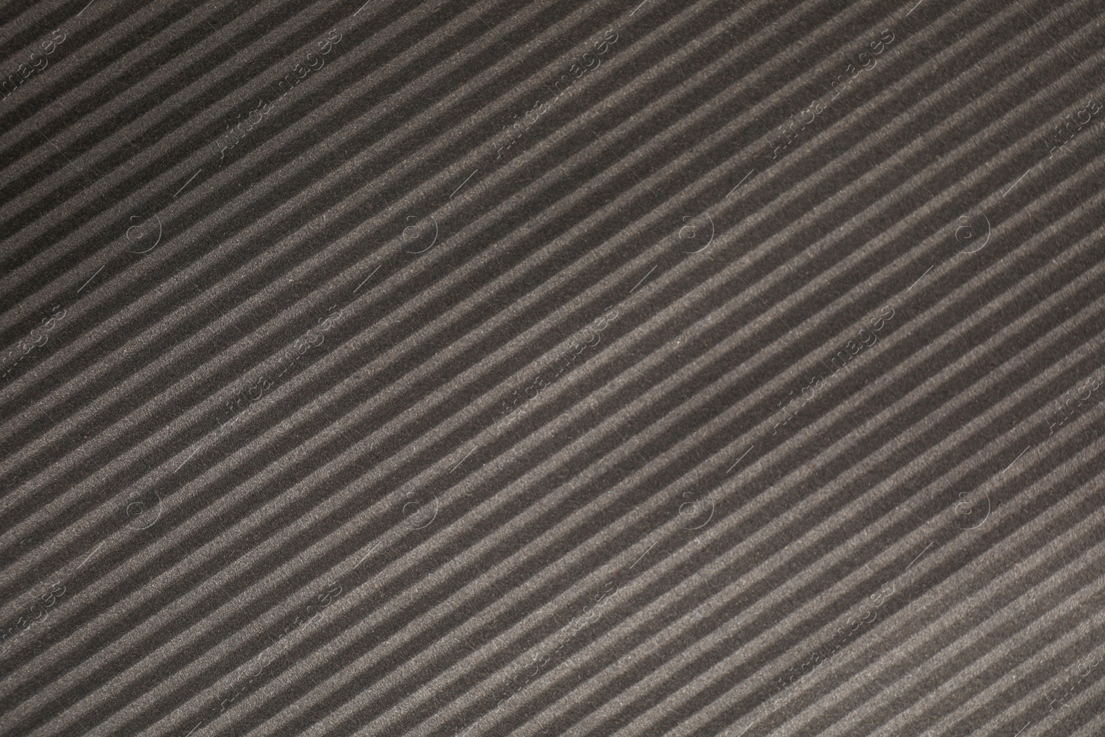 Photo of Dark grey corrugated sheet of cardboard as background, closeup